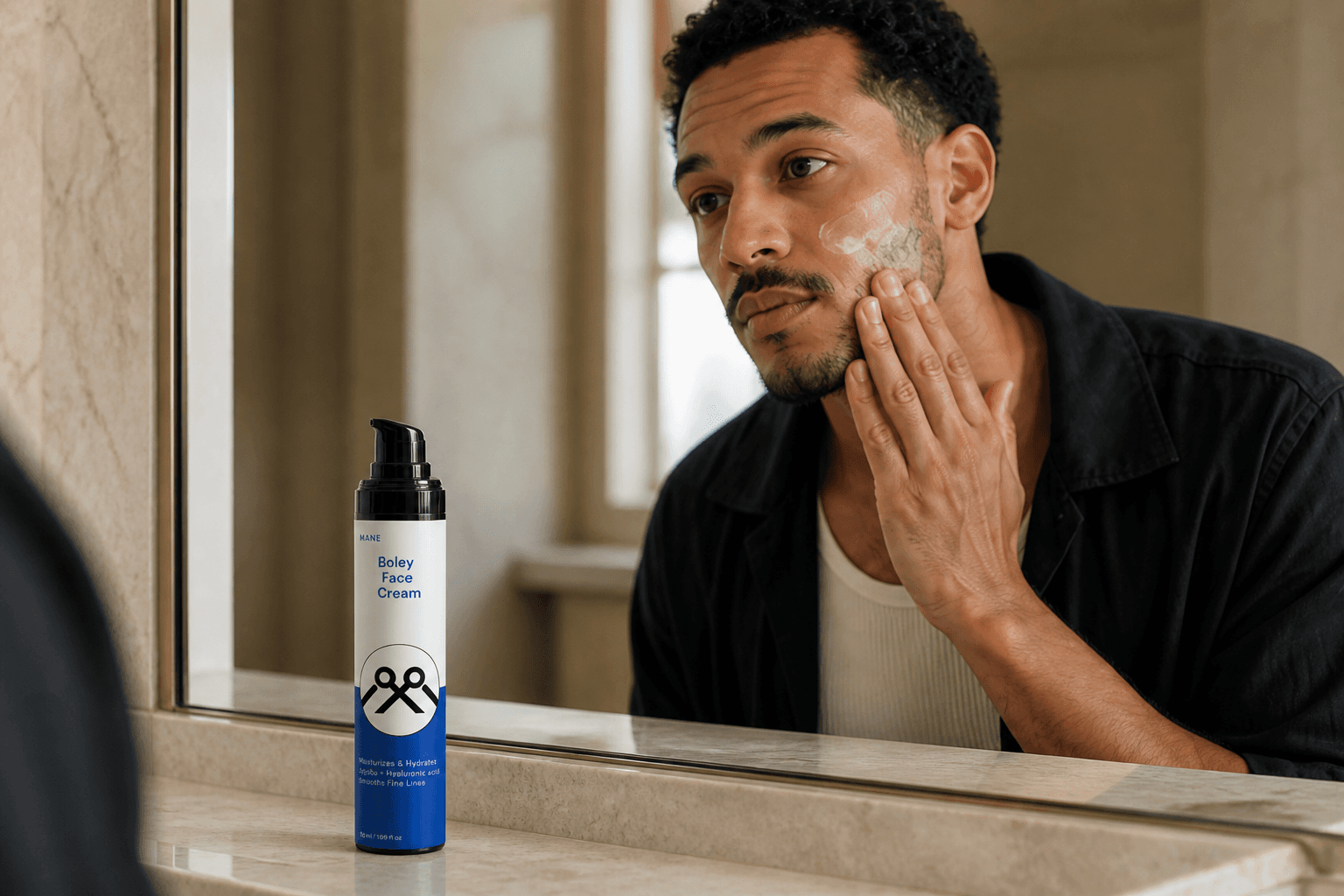 Man applying MANË Boley Face Cream while looking in a bathroom mirror
